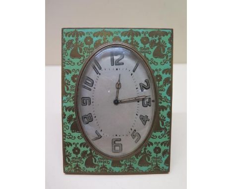 An 8 day Swiss made desk clock, 12cm x 9cm, oval dial brass case with green enamel with floral decoration, no:1026280, runnin