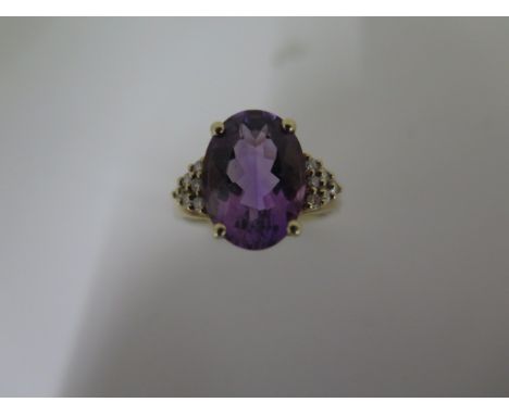 A 9ct yellow gold amethyst and diamond ring, size P 1/2, hallmarked, amethyst approx 14mm x 10mm x6.5mm, in good condition