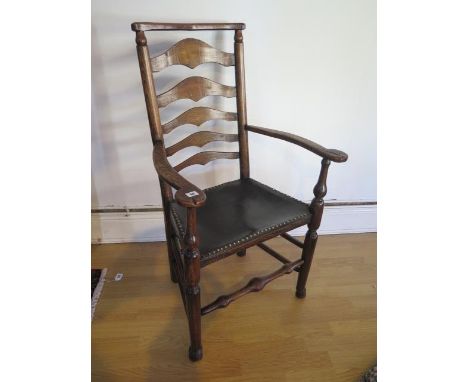 An antique, circa 1800, ash and elm ladder back elbow chair with leather seat in polished condition, 109cm tall x 66cm wide 