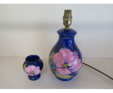 A Moorcroft table lamp, 26cm tall, in working order with a matching vase in good condition 