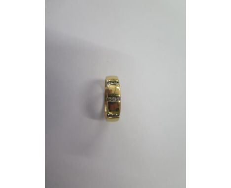 An 18ct yellow gold diamond band ring marked 750, 0.15ct, size L/M, approx 4.7 grams, in good condition some small usage mark