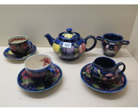 A Moorcroft teapot, a sugar bowl, milk jug, two cups, three saucers, all have crazing, chip to one cup, handle repair to jug 