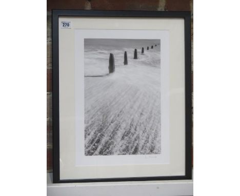 An L Munro signed black and white photographic print of a seascape scene, frame size 53cm x 43cm, printed on archival paper o
