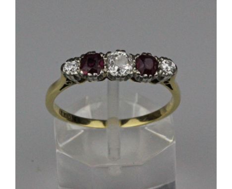 A ruby and diamond five stone ring, the claw set central old brilliant cut diamond 4.1mm x 4mm flanked by two oval faceted ru