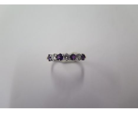 A hallmarked 18ct yellow gold diamond and amethyst ring, size P/Q, approx 2.6 grams in good condition (ref 7207) 