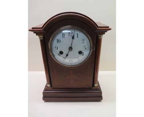 An 8 day mahogany case striking mantle clock, 33cm tall, some small inlay loss but running 