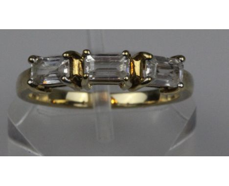 A 9ct gold three baguette cut white sapphires ring, approx diamond weight 0.45ct, hallmarked 375, makers initials 'DK', size 