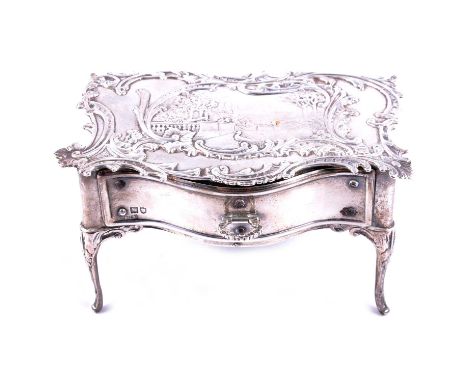 A silver jewel casket in the form of a side table with drawer, London 1902, the top having a scenic landscape to centre and s
