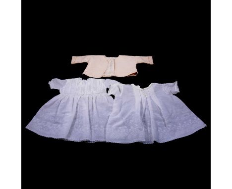 A quantity of vintage children's christening silk and lace dresses, and a quilted jacket.