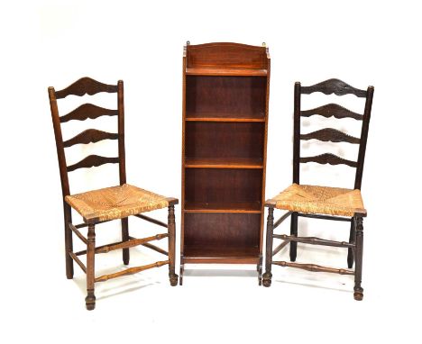 Edwardian mahogany narrow bookcase, width 41cm, height 117cm, and a pair of 19th Century ladder back chairs with rush seats.Q