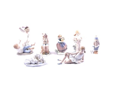 Seven Lladro and Nao figurines, including Nao Pillowfight, two Lladro girls with flower, Eskimo child and Polar Bear Cub, Lla