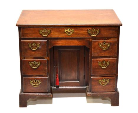 George III mahogany kneehole desk, top with moulded edge and rounded corners, seven drawers and a cupboard, bracket feet, wid
