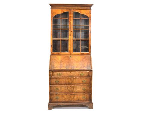 George III style walnut bureau bookcase, moulded cornice aboe glazed doors enclosing three adjustable shelves, the base with 