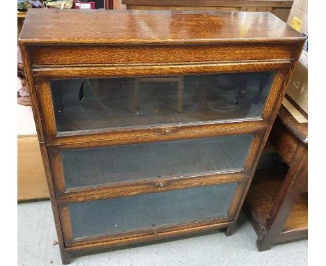 A 20th century oak Globe Wernicke three section bookcase, 113cm high, 86cm long 25cm wide