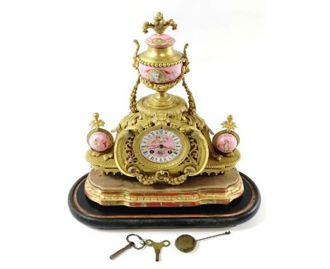 A late 19th century French ormolu and painted porcelain mantel clock upon a shaped giltwood stand; 2 train movement striking 