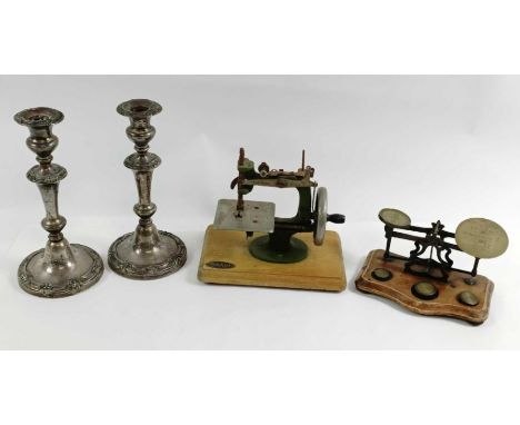 A vintage set of brass postal scales, along with a Grain sewing machine and a pair of candlesticks 