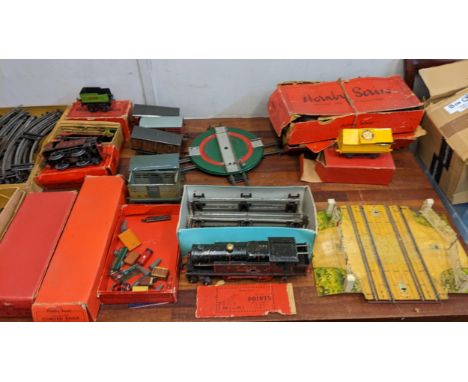 A collection of Hornby 0 gauge model railway accessories to include track, a level crossing, three locomotives, brake vans an