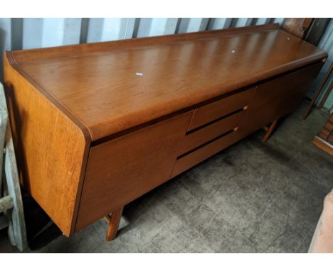 A 1960s White & Newton 'Petersfield' teak sideboard with concave ledge back above an arrangement of three drawers flanked by 