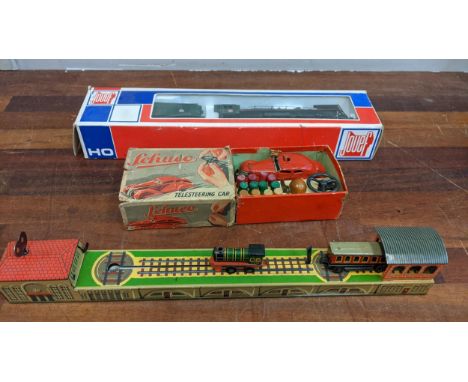 A group of vintage toys to include a Schuco Tele Steering car in its original box A/F, a German tin plated wind-up train and 