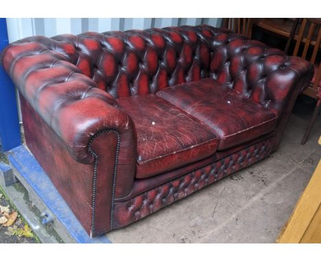 A Victorian style Chesterfield red leather button back upholstered two-seater sofa 68cm h x 159cm w Location:If there is no c