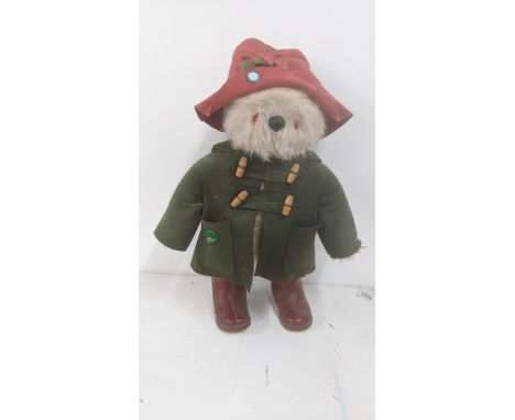 A Gabrielle design 1970s Paddington bear with a red felt hat and green felt duffle coat and red Dunlop wellingtonsLocationIf 