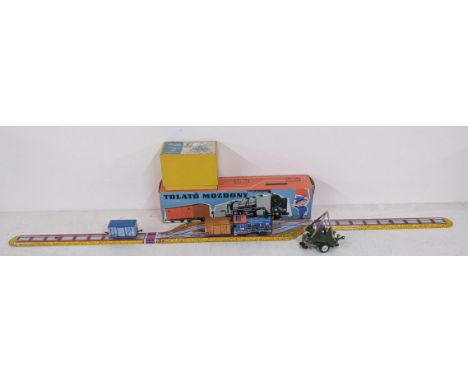 A boxed Hungarian tin plate railway Tolato Mozdony with an engine and two carriages (unable to connect two carriages at once)