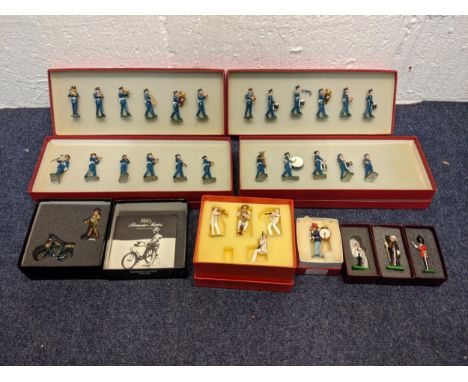 Model toy soldiers to include a military band, a soldier and bicycle, another band dressed in red and white striped jackets a