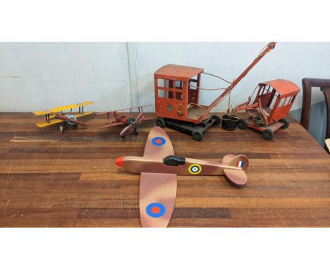 A collection of toys to include two metal plated WW1 planes in RAF and Luftwaffe livery, two Tri-ang cranes and a wooden mode