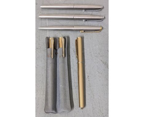 A group of unboxed pens to include two Parker 45 fountain pens, three gold coloured enamel Pentique pens to include a ballpoi