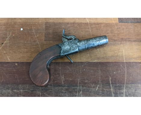 A 19th century overcoat pistol with proof marks to underside of barrel and engraved Firing Plates marked Minton London Locati