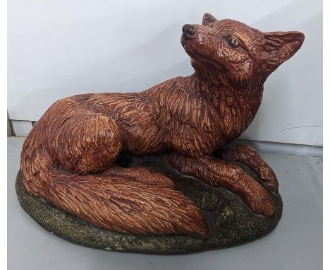 A garden stoneware model of a fox on a naturalistic base, 27cm h x 38cm wLocation:If there is no condition report shown, plea