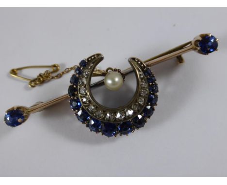 LATE 19TH CENTURY SAPPHIRE AND DIAMOND SET CRESCENT BAR BROOCH FLANKED BY SAPPHIRE SET TERMINALS WITH A SEED PEARL CENTRE