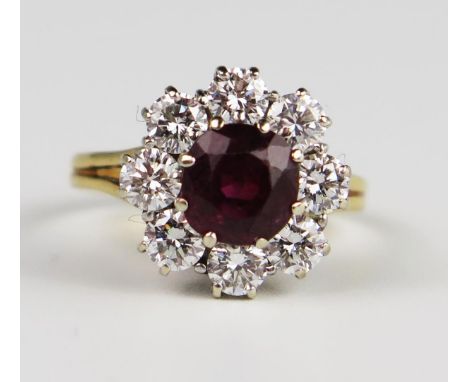 An 18ct Yellow Gold, Ruby and Diamond Cluster Ring, the 6.5 mm principal stone surrounded by 8 x c. 3.25mm brilliant round cu