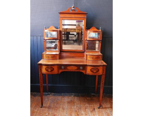 An Edward &amp; Roberts Satinwood and Mahogany Shape Front Dressing Table with foliate marquetry inlay, the central bevelled 