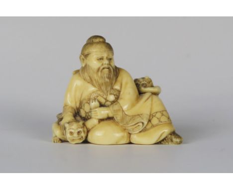 A 19th Century Japanese Ivory Netsuke of a seated man with two devils, signed. **CONTAINS IVORY** UK SHIPPING ONLY** 