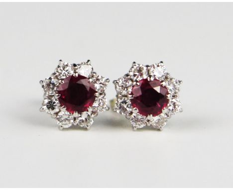 A Pair of Ruby and Diamond Cluster Stud Earrings, the central c. 5.2mm stones surrounded by eight c. 2.6mm round cuts (EDW 1.