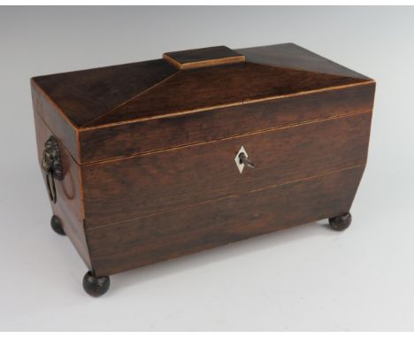 An Early 19th Century Rosewood and Boxwood Strung Tea Caddy with twin lion mask handles and standing on four ball feet, 33(w)