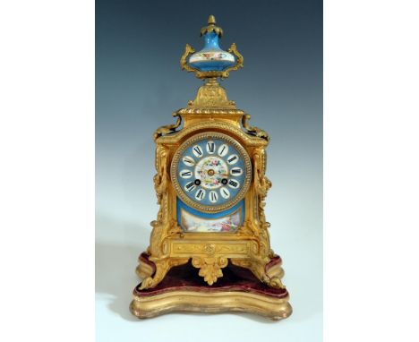 A 19th Century French Gilt Metal Mantle Clock with Sevres Panels and on a gilt wood base, striking movement stamped OR 579 94