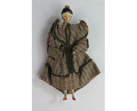 A Grodnertal Wooden Doll with Yellow Comb, original painted decoration and costume with double articulated arms and single ar