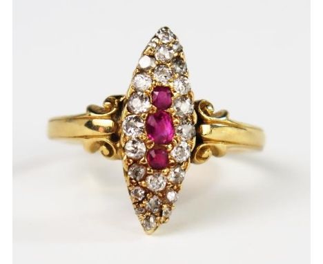 An Antique 18ct Gold, Old Cut Diamond and Ruby Marquis Ring with scrolling decoration to the shoulders, size N.5, 4.4g. Head 