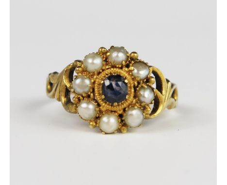 A Good Georgian Amethyst and Pearl Cluster Ring in an unmarked gold setting with pierced foliate shoulders, 14 mm head, size 