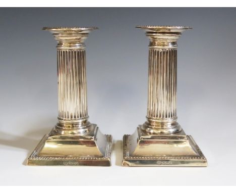 A Pair of Edward VII Silver Candlesticks with reeded columns and detachable sconces, Sheffield 1905, William Hutton &amp; Son