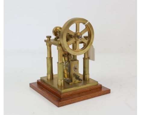 Scratch built brass and steel model of an engine with single wheel and piston, on integral hardwood base, 16.5cm high, inscri