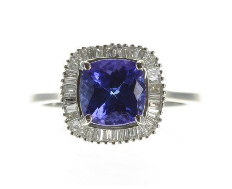 Fine quality platinum AAAA tanzanite and diamond cluster ring, the tanzanite 2.75ct approx, in a cushion setting of tapered b