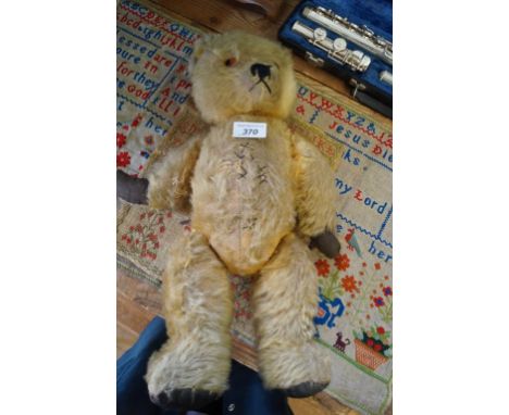 An Irish gold plush teddy bearWith glass button eyes and articulated limbs, height 45cm.