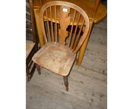 A Victorian elm and beech stick back Windsor chair, with ornately shaped splat back above the dished seat, the four turned su