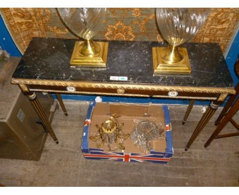 A reproduction Italian style marble topped console table raised on gilt and black column supports.   CONDITION REPORT:  small