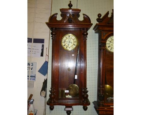A 19th Century continental glazed beech cased Vienna-type wall clock, the circular enamel dial with subsidiary dial above two