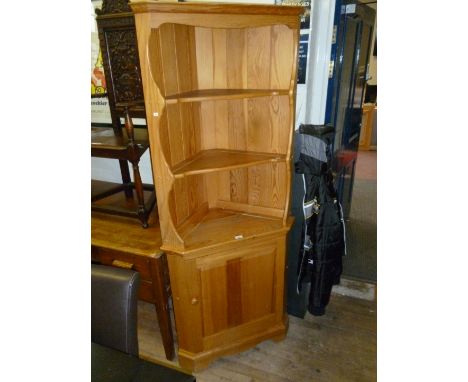 A good quality Ercol light elm freestanding corner cupboard with single cupboard door