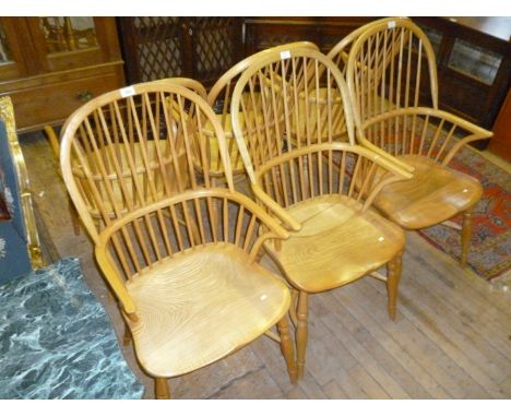 A set of six reproduction Georgian style elm and beech comb back Windsor armchairs, the turned tapering supports united by cr